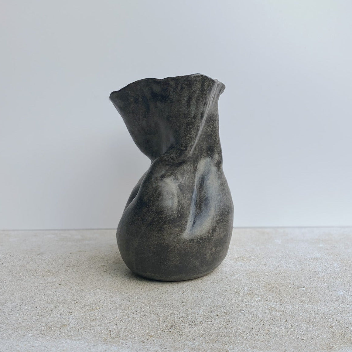 Ceramic vase on a white surface with a neutral background