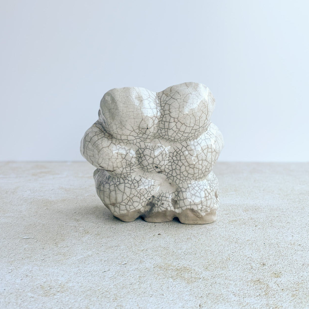 Ceramic sculpture with raku white crackle glaze on a textured surface